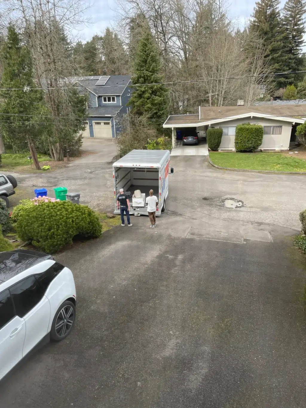 Two CLP workers loading a U-Haul trailer